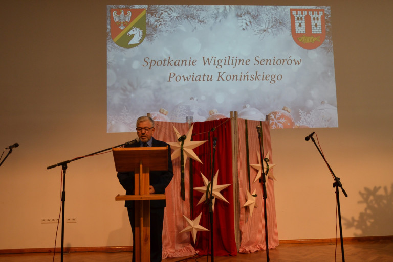 Mężczyzna przemawia przy mównicy.